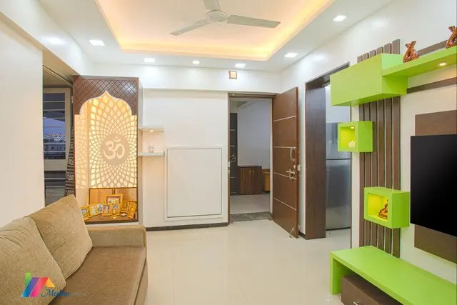 A living area with green display shelves and an illuminated prayer niche.