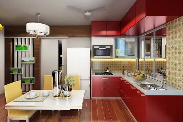 A kitchen with red lower cabinets, glass-front cupboards and a breakfast table.