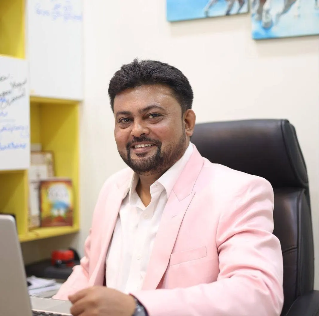 Studio founder seated at his desk.