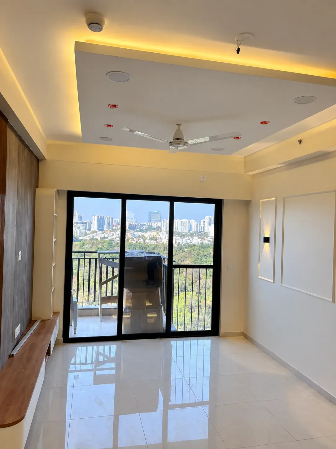 Living room with recessed ceiling lighting and balcony doors.