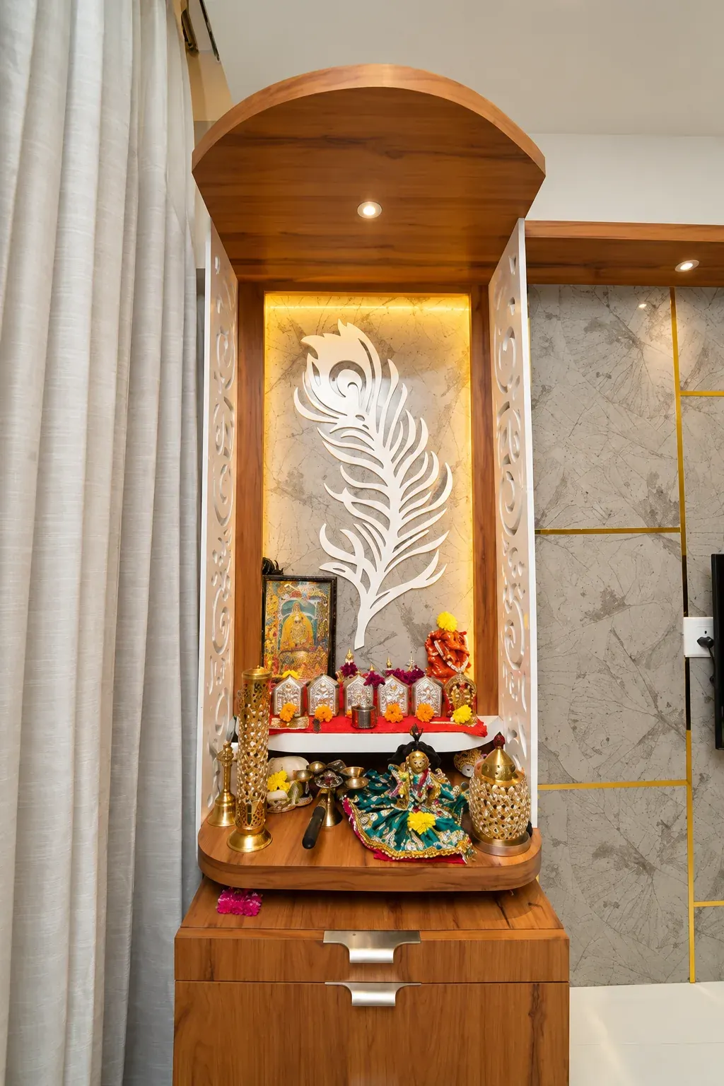 Illuminated timber prayer cabinet with a decorative white motif.