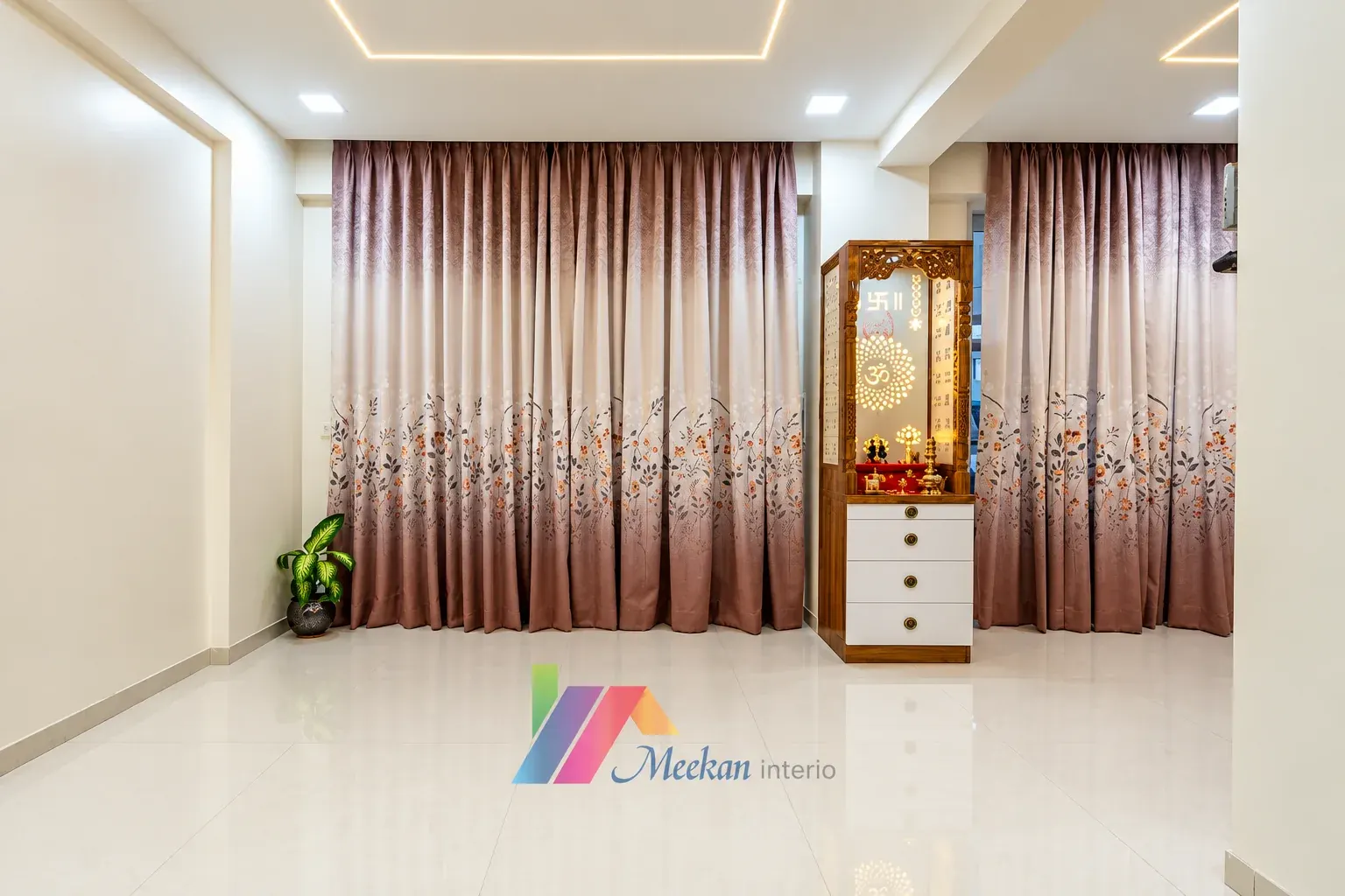 Living area with floral curtains and a prayer cabinet between the windows.