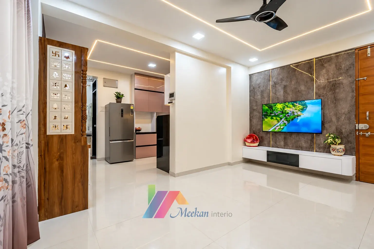 Living room with a television wall, glazed partition and recessed ceiling lights.