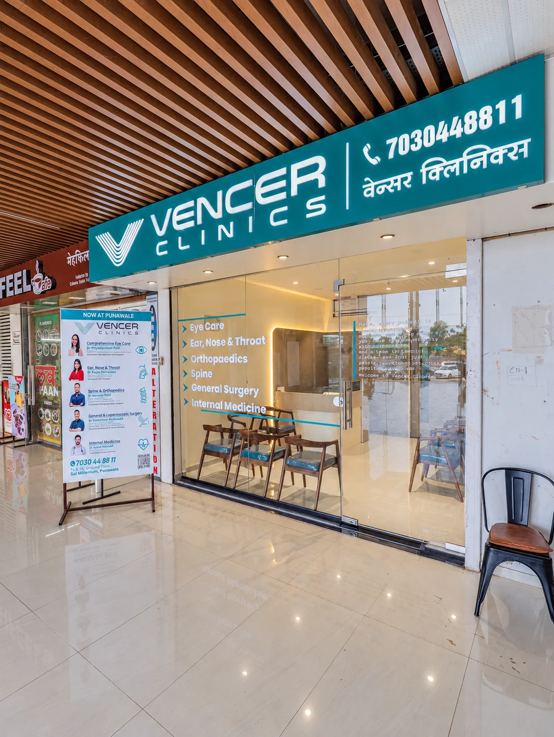 Glass-fronted Vencer Clinics entrance beneath teal signage and a timber slatted canopy.